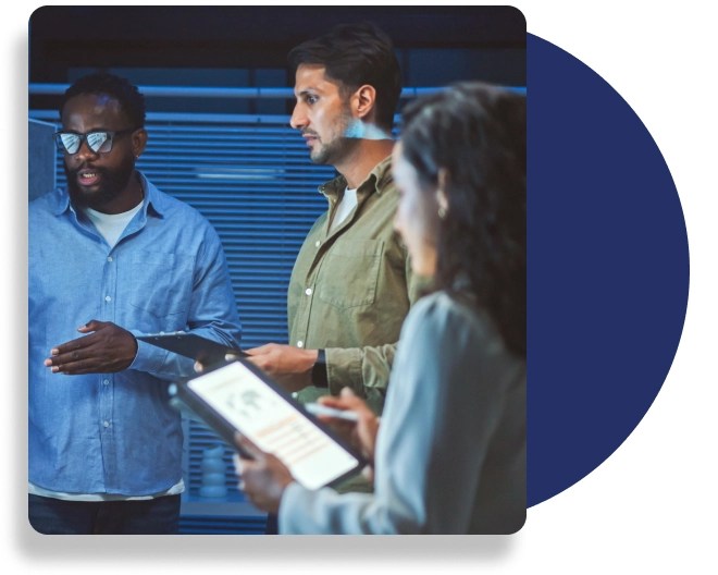 A group of professionals, one of whom is holding a digital tablet.