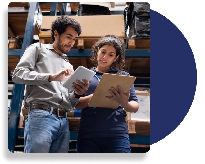 Two professionals in a warehouse setting.