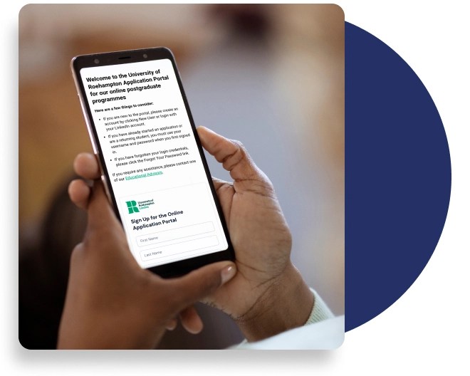 Close-up of a hand holding a smartphone displaying Roehampton University's online postgraduate application portal with welcome text and form fields.