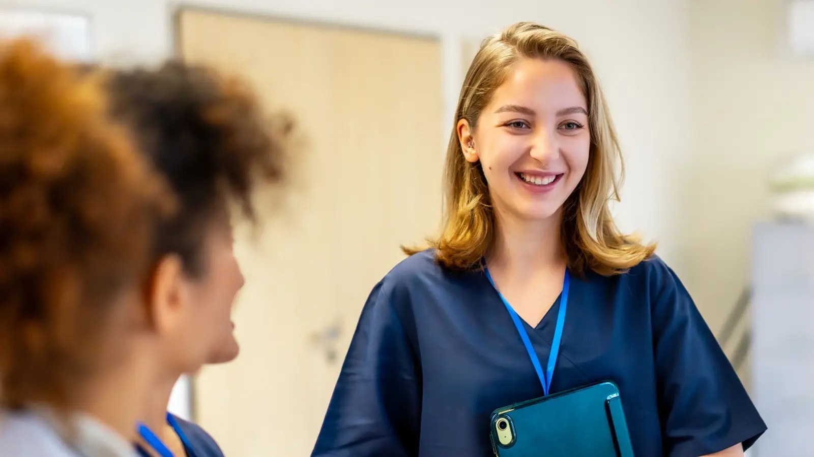 Woman in scrubs smiling